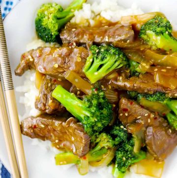 Beef and broccoli on a plate with chopsticks