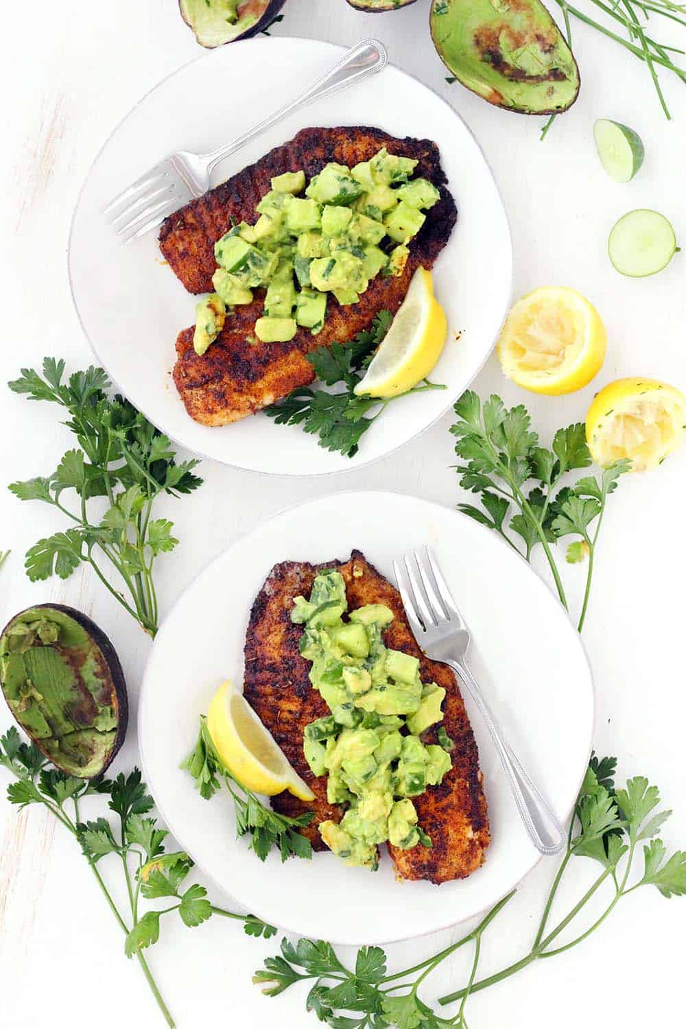 This super flavorful Blackened Tilapia comes together in less than 10 minutes!! Topped with a cool and refreshing avocado cucumber salsa, this is the perfect quick and easy low-carb recipe. Paleo, gluten free, and whole30 compliant.