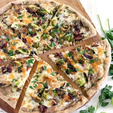 Brussels Sprout and Bacon Pizza is a match made in heaven and a FOUR INGREDIENT recipe! A white pie with seared brussels sprouts, crunchy bacon, and mozzarella cheese baked on a cast iron pizza pan until bubbly with a whole wheat crust. YUM.
