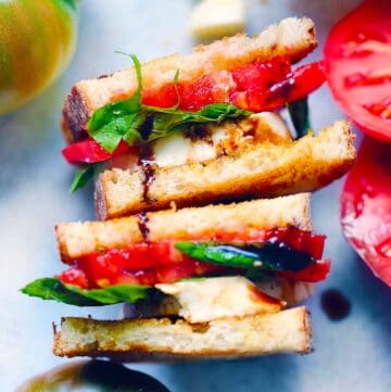 Square photo of a caprese sandwich sliced in half.