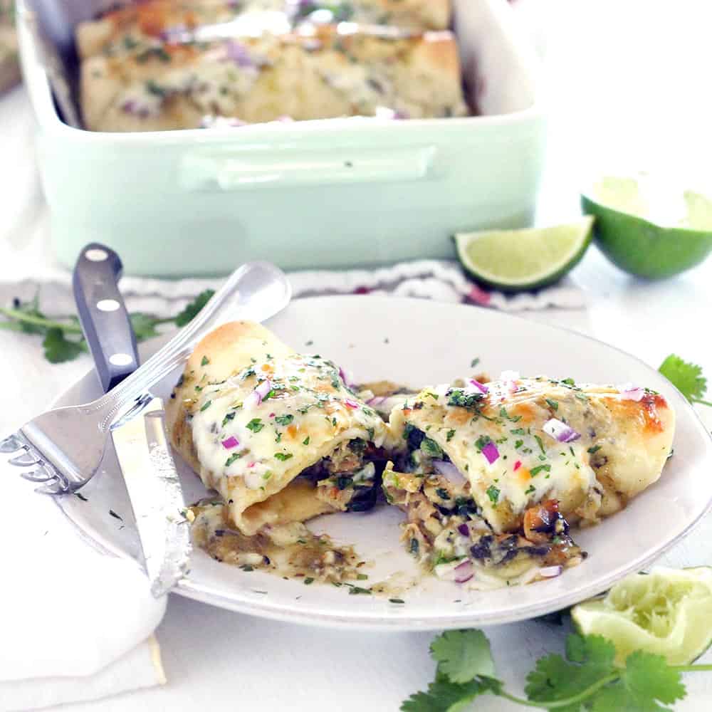 These Chicken and Spinach Enchiladas Verdes are my FAVORITE enchiladas! The recipe is freezable and packed with healthy greens, the chicken is marinated in a delicious jalape&ntilde;o garlic mixture, and they're topped with jarred roasted tomatillo salsa for a quick and easy shortcut.