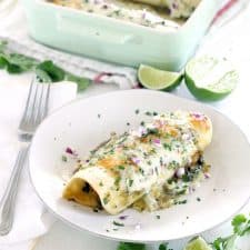 These Chicken and Spinach Enchiladas Verdes are my FAVORITE enchiladas! The recipe is freezable and packed with healthy greens, the chicken is marinated in a delicious jalape&ntilde;o garlic mixture, and they're topped with jarred roasted tomatillo salsa for a quick and easy shortcut.