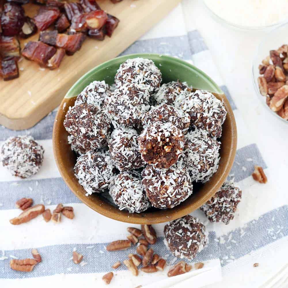 These Whole30 / Paleo chocolate coconut energy balls are an amazing midday snack and energy boost! Sweetened only with dates and super easy to make, they taste decadent, similar to an almond joy, but are 100% guilt-free.