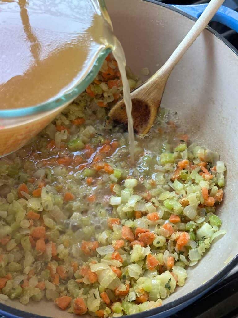 Adding broth to soup.