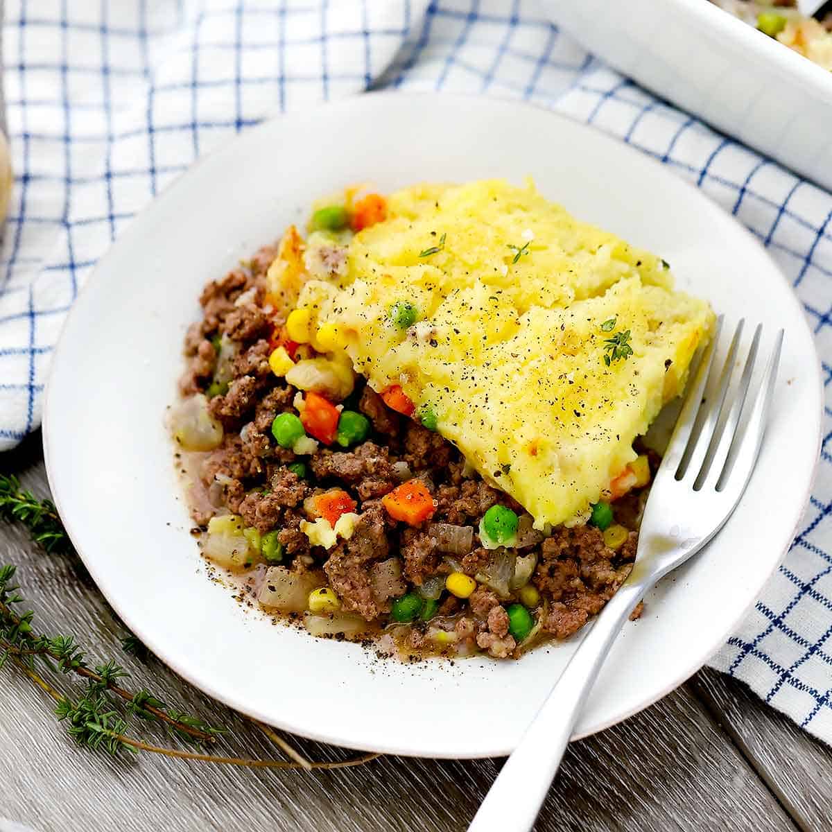 A plate of cottage pie and a fork.