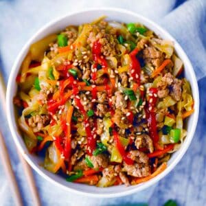 Square photo of egg roll in a bowl.