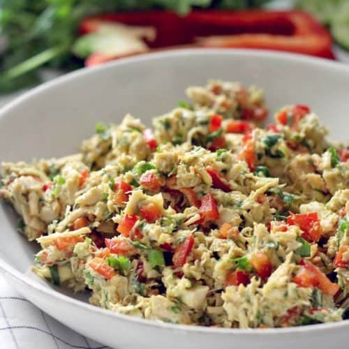 A bowl of fiesta chicken salad made with avocados and bell peppers