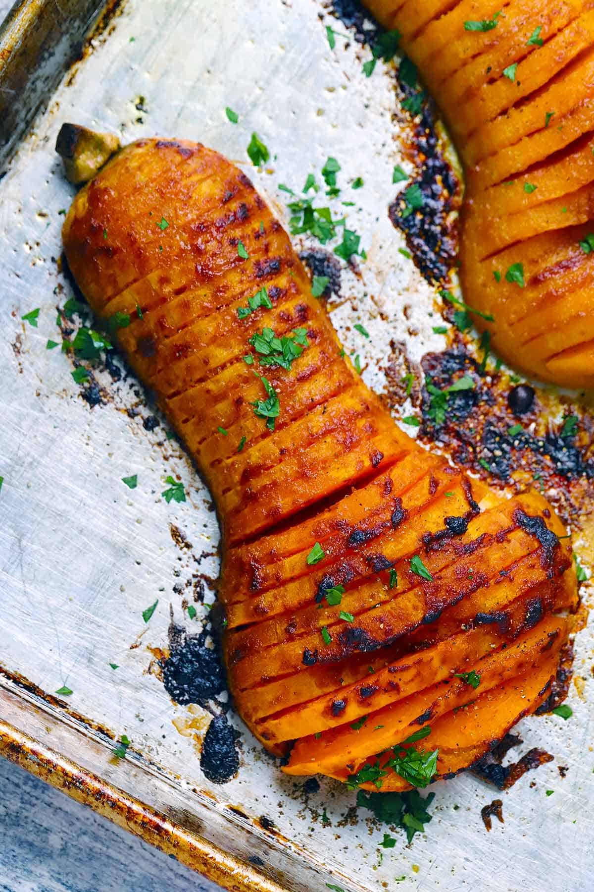 Overhead photo of a hasselback butternut squash on a baking sheet.