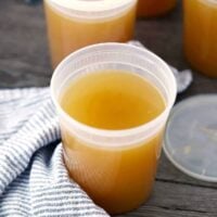 A container of homemade chicken stock