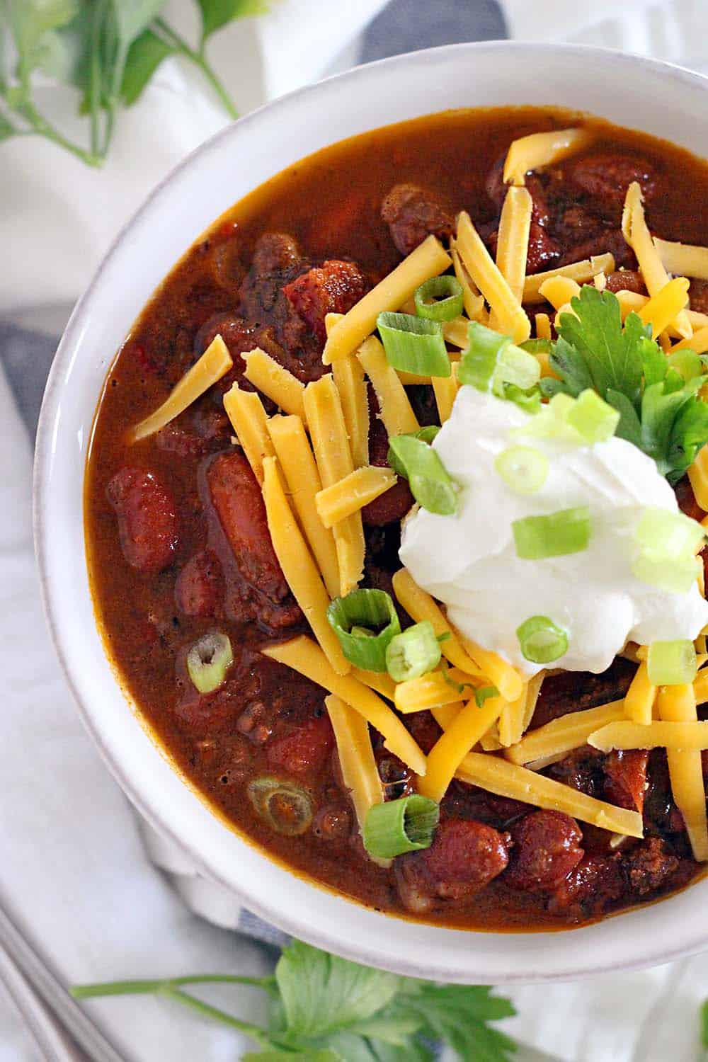 This Instant Pot Chili is made with ground beef and dry kidney beans, and comes together in less than an hour! It's cheap, healthy, and DELICIOUS.