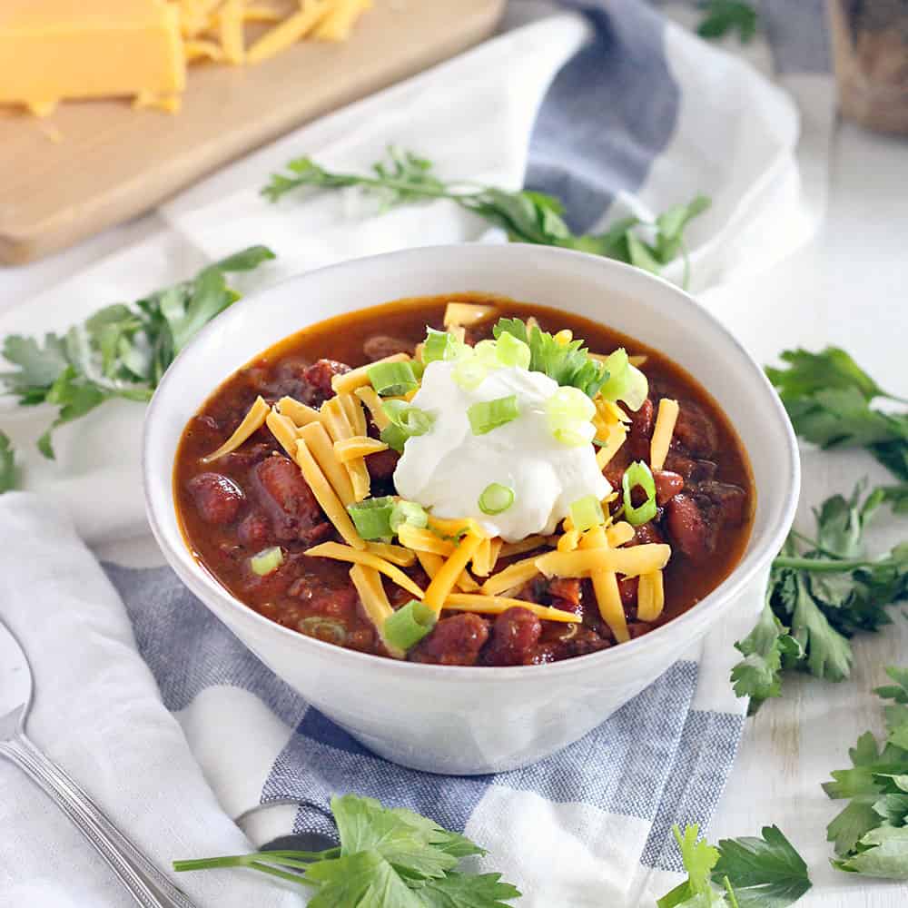 This Instant Pot Chili is made with ground beef and dry kidney beans, and comes together in less than an hour! It's cheap, healthy, and DELICIOUS.