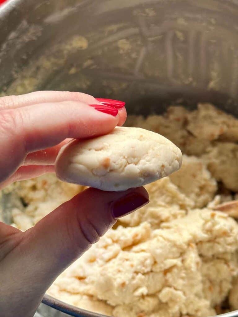 Forming kourabiedes into shapes before baking.