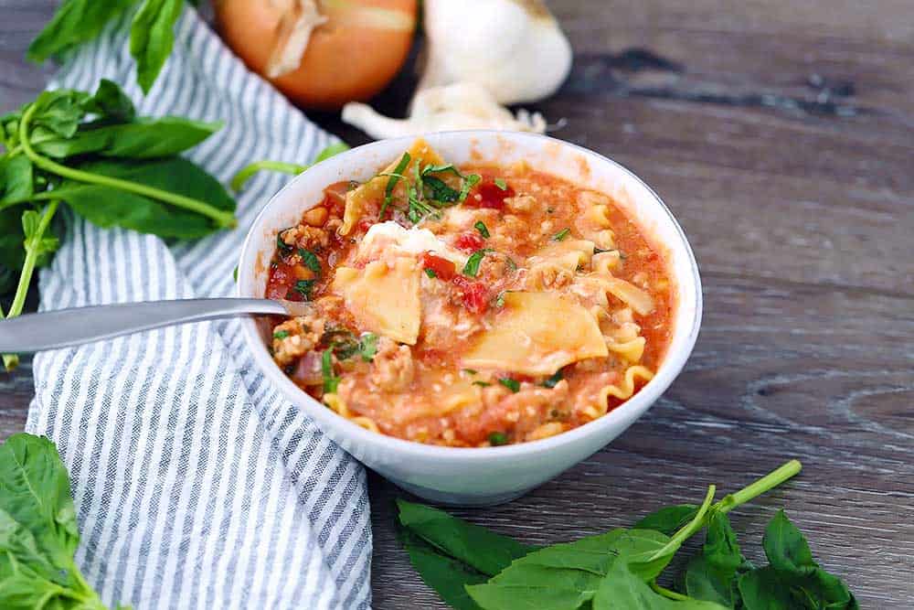Horizontal photo of a bowl of lasagna soup.