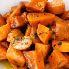 These Glazed Sweet Potatoes are coated in a mixture of melted butter, fresh rosemary, and maple syrup, then baked in the oven until super tender. They're not too sweet, and they're the perfect vegetarian, gluten-free side dish!