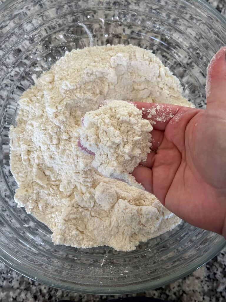 Showing the crumbly texture of butter mixed with flour base mixture for mini scones.