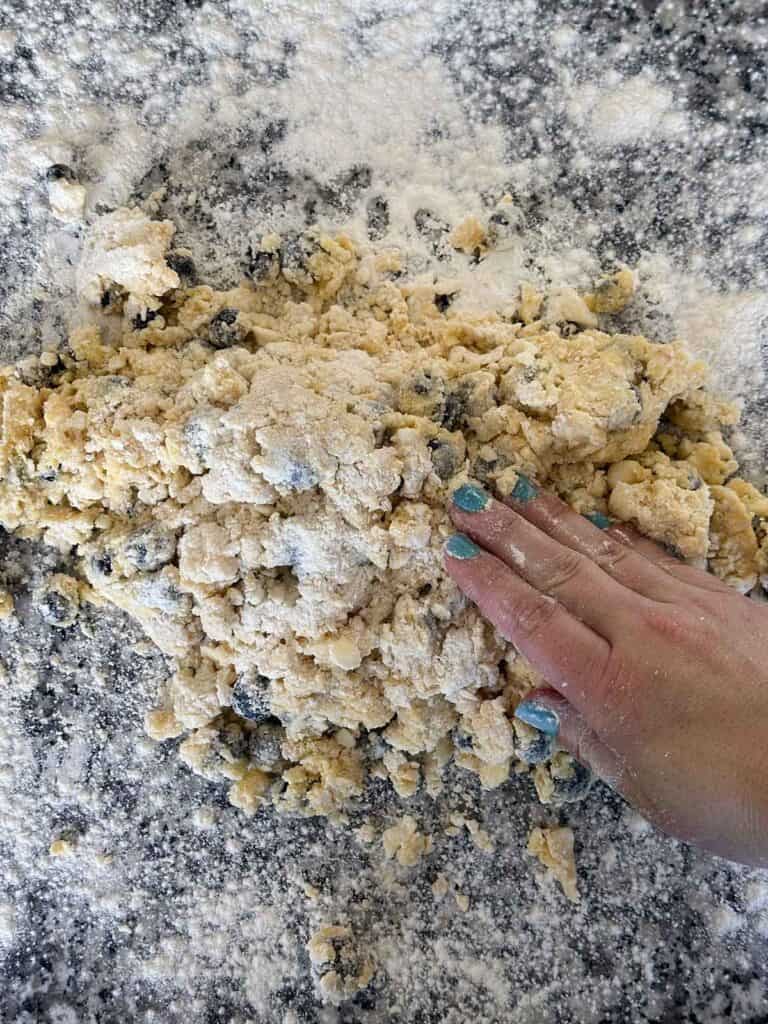 Shaping scone dough on a floured surface.