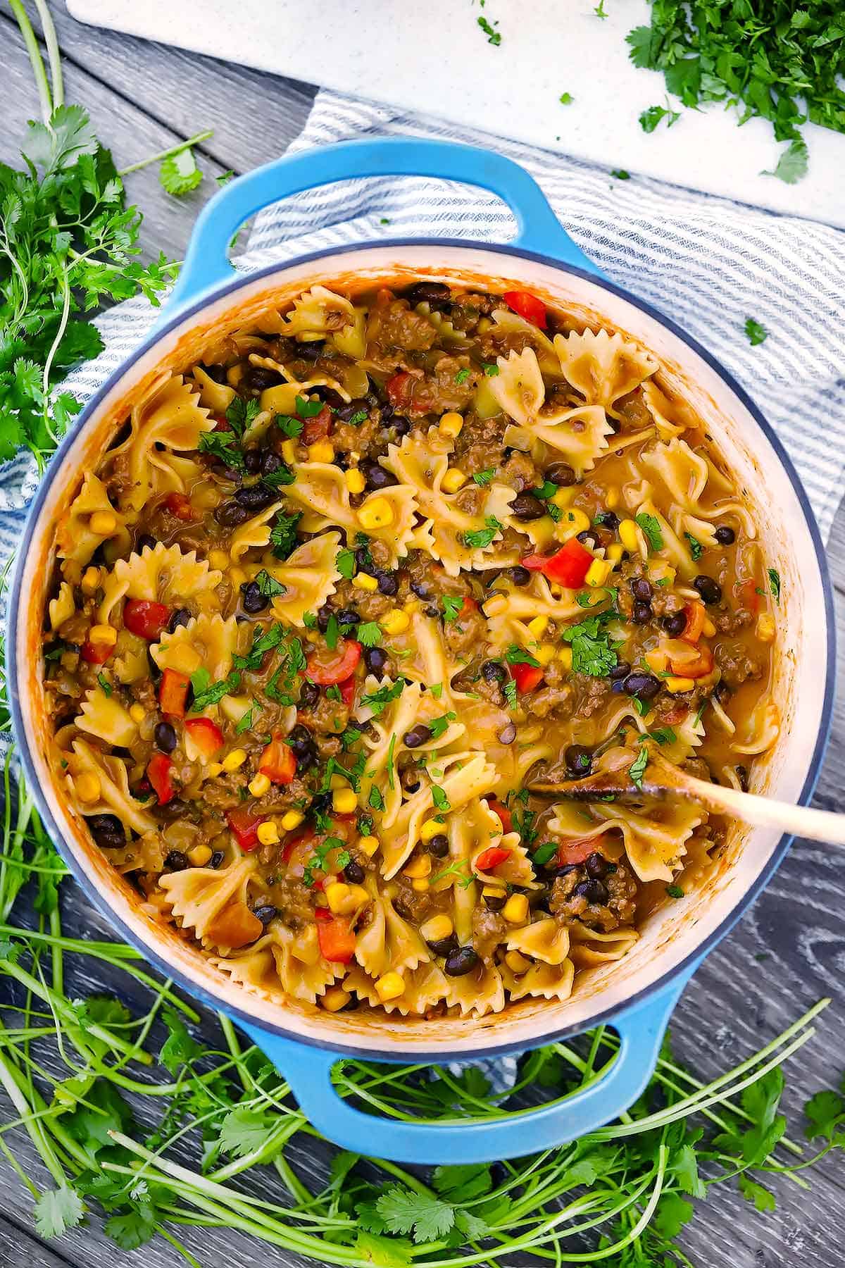 Overhead photo of one pot cheesy taco pasta in a Dutch oven.