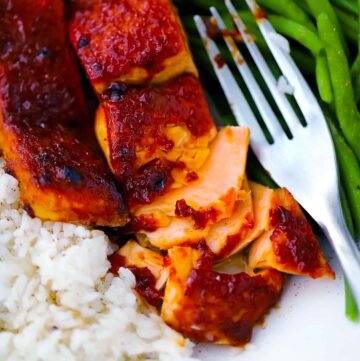 Square photo of oven bbq salmon flaked apart.