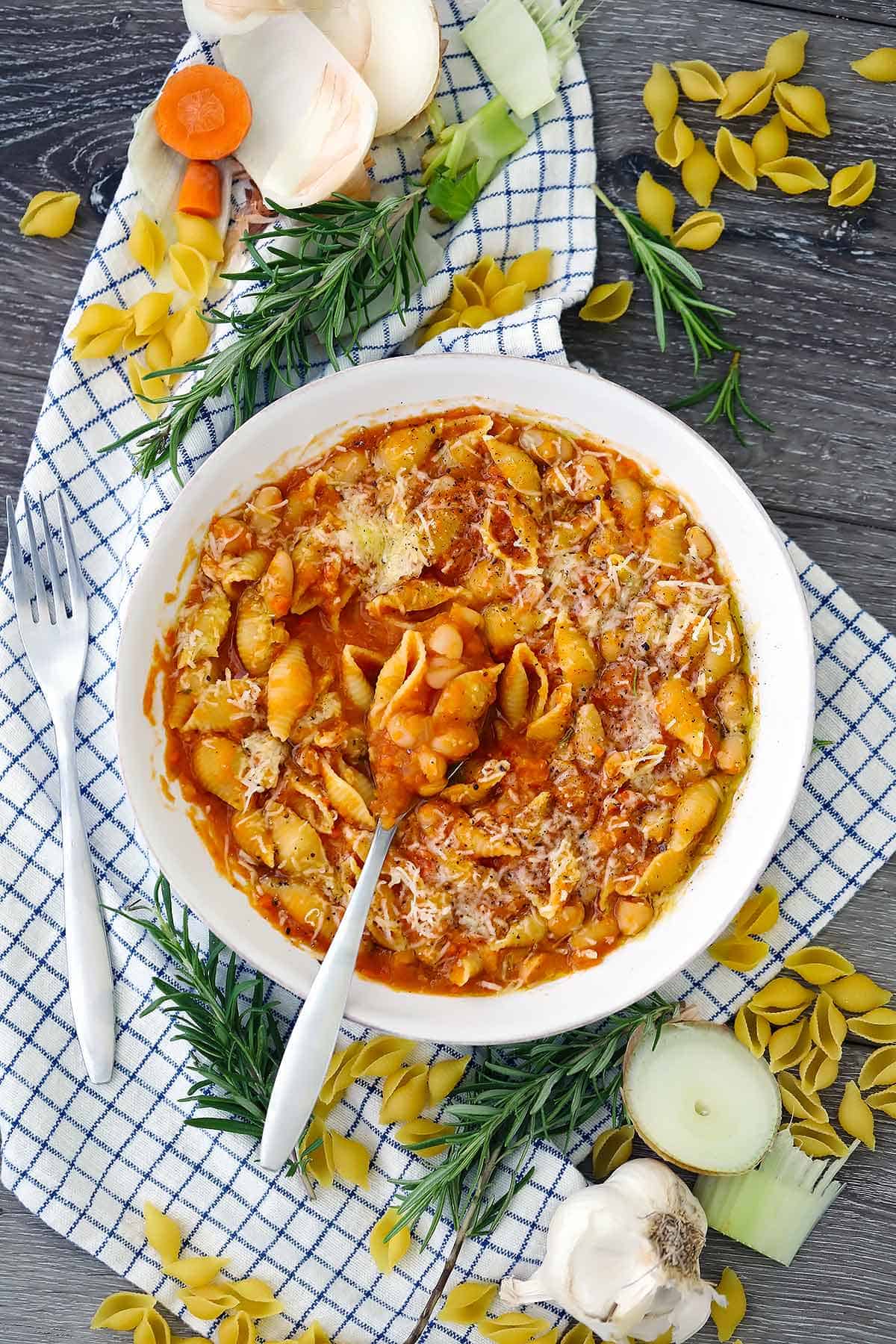 An overhead photo of pasta e fagioli with a spoon.