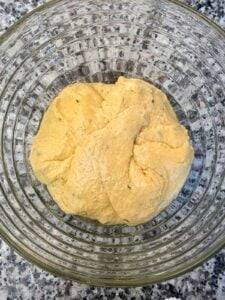 The dough for no knead pumpkin bread in a bowl, before rising.