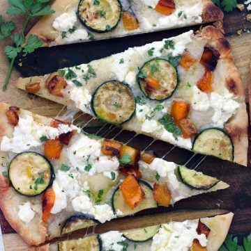 This vegetarian Sautéed Vegetable and Goat Cheese Naan Pizza recipe comes together in only 20 minutes for an easy weeknight dinner! Tip: place the baking rack in the lower half of the oven for a crisp crust.