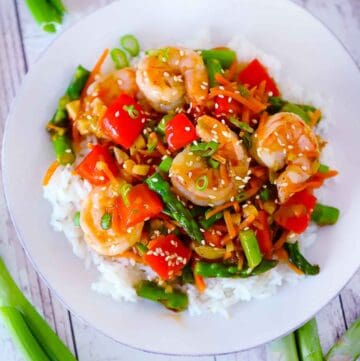 Square photo of shrimp stir fry with vegetables.