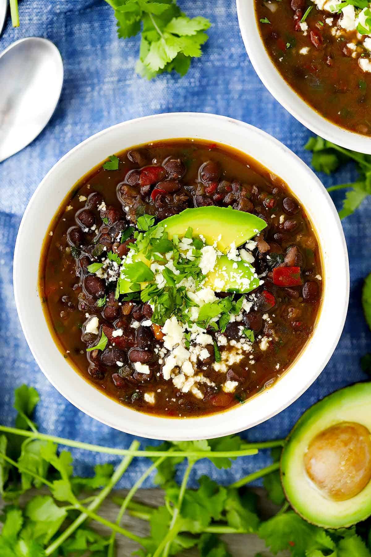 An overhead vertical image of a bowl of black bean soup.