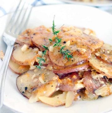 These Slow Cooker Scalloped Potatoes are rich and creamy and smothered in Gruyere and Parmesan cheese. It's the perfect thing to make for Thanksgiving dinner because it frees up space in your oven and on your stove top!