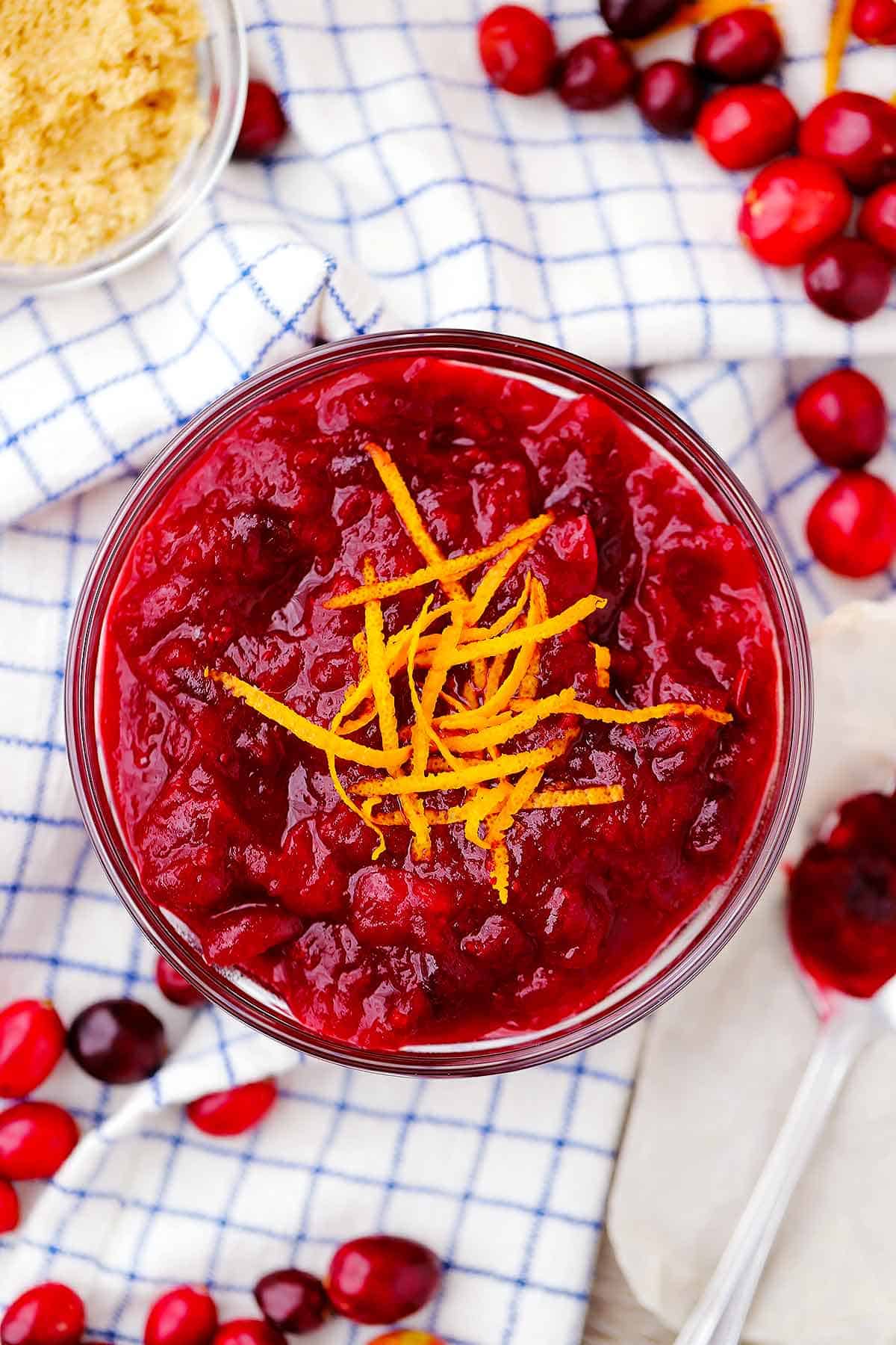 Overhead photo of fresh cranberry sauce with orange zest on top.
