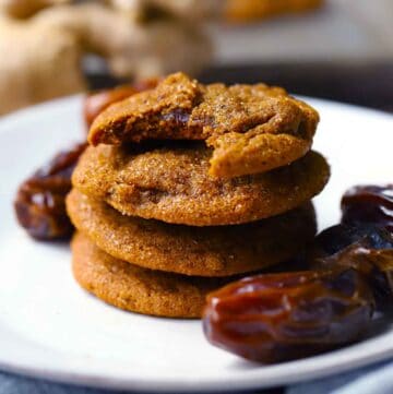 Square photo of a stack of fresh ginger and date cookies.