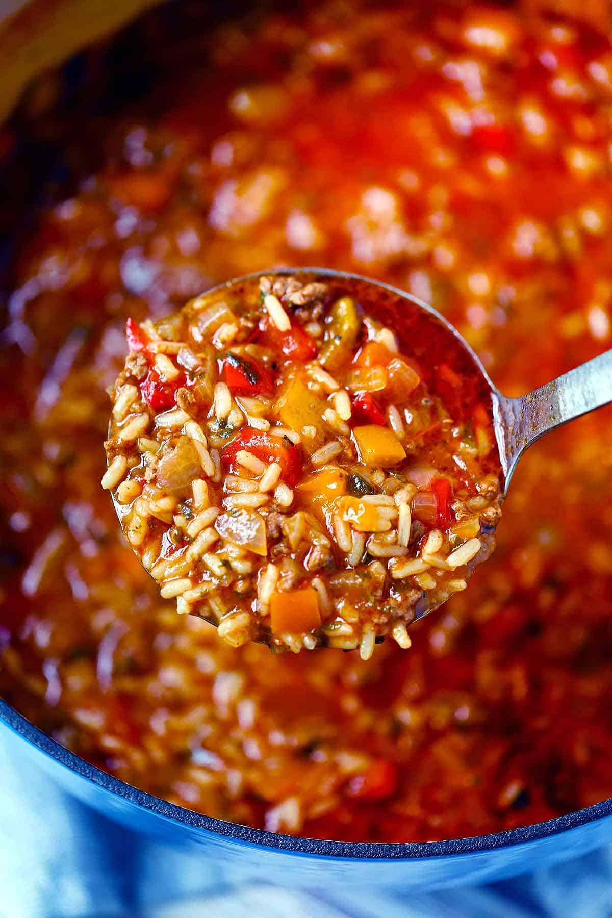Close up photo of a ladle full of stuffed pepper soup.