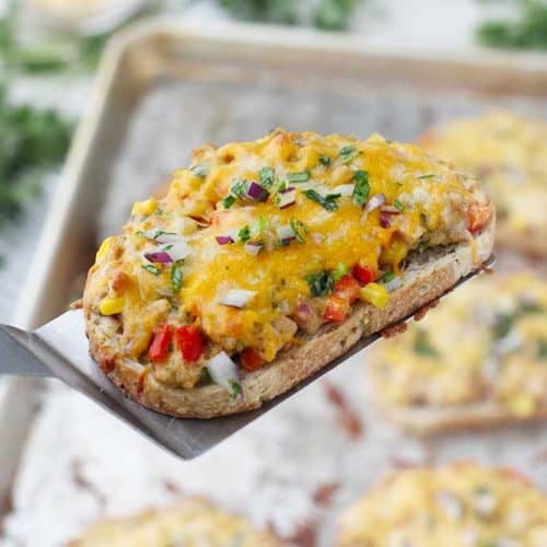 Tex Mex Tuna Melts are such a fun twist on a classic! Corn, bell peppers, jalapeño, cilantro, and onion are mixed in tuna, spread on bread, and topped with Mexican cheese, then baked until melty. Such an easy weeknight dinner recipe!