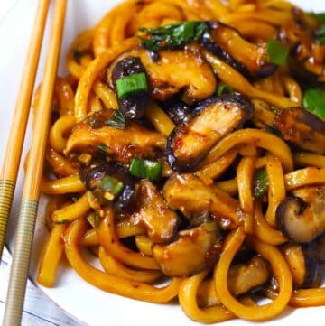 Square Photo of Udon Noodle Stir Fry with Mushrooms.
