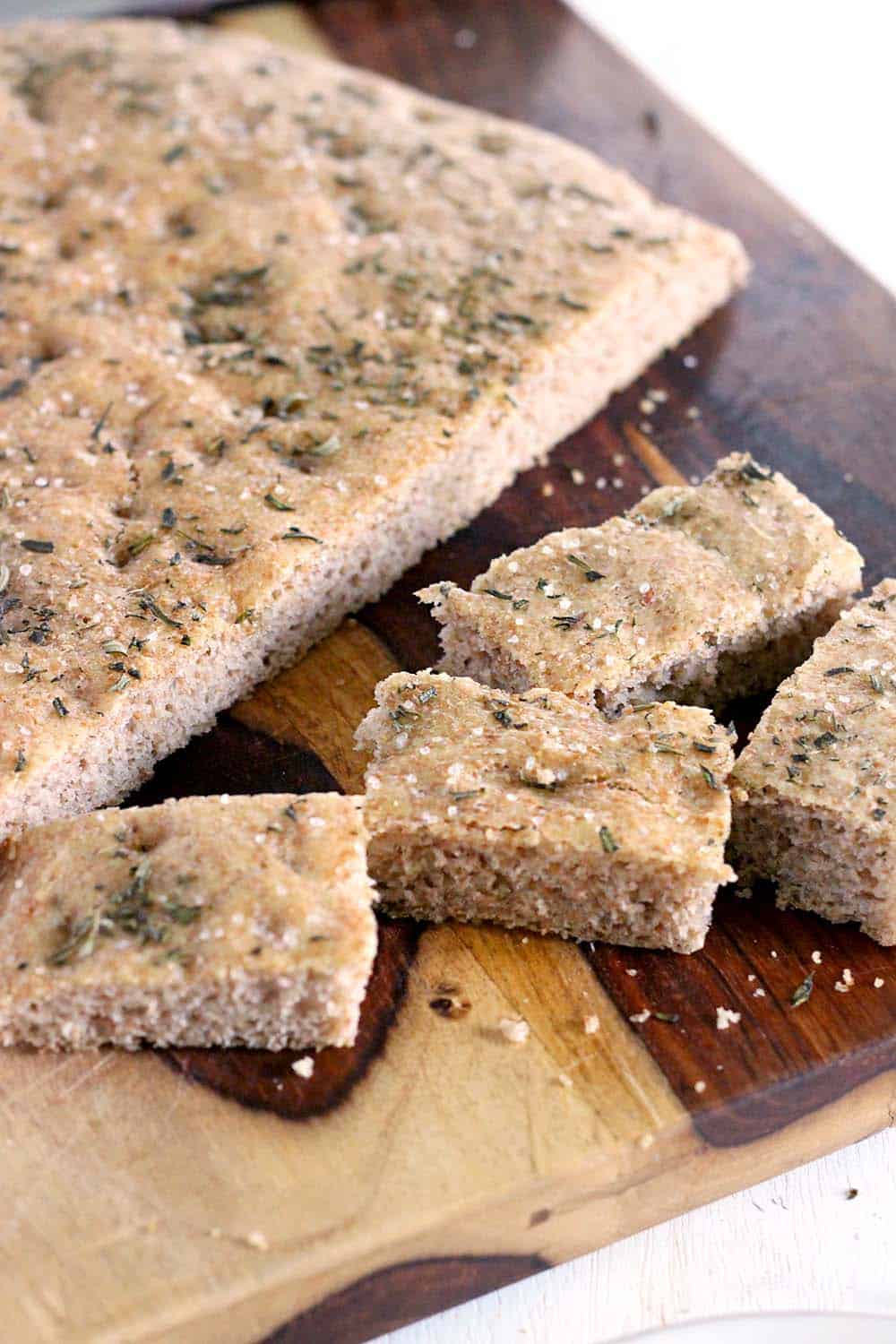 This whole wheat no knead focaccia with rosemary and sea salt is so delicious and easy to make, you'll never need to go to the bakery again!