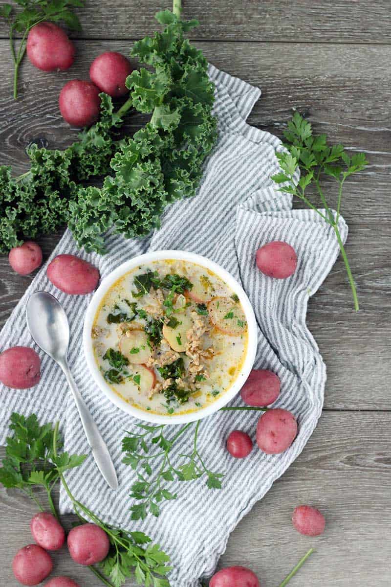 The Olive Garden's famous Zuppa Toscana is so easy to make from scratch at home with only a few ingredients! A creamy, gluten-free soup with Italian sausage, potatoes, and kale.
